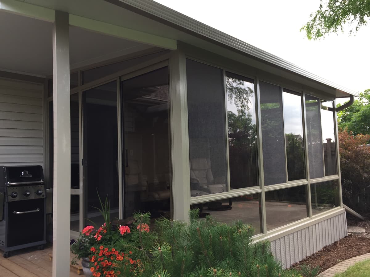 Family enjoying bug-free 3 season sunroom in Sarnia Ontario